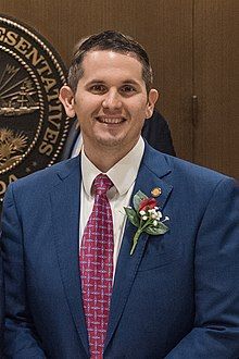 Head and shoulders of a smiling 30ish man with dark hair