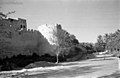 A view of the northern wall of Qatif Castle, connected to the palm forests of Mazraat al-Shammasiya, captured in 1945.