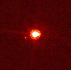 Eris (centre) and Dysnomia (left of centre), taken by the Hubble Space Telescope.