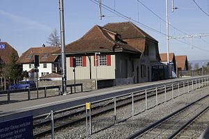 Two side platforms next to two-story station building