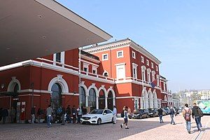 Three-story building with hip roof and two-story wings