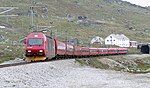 An NSB El 18 hauled express train just leaving the Finse Tunnel