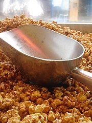 Large aluminum scoop, here with caramel corn