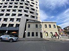 An image of an apartment building adjacent the heritage Canada Hotel, viewed from the street.