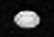 A white oval shaped object somewhat elongated horizontally is seen in the center. There are a few small dark spots on its surface.