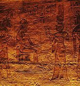 Nefertari offering sistra to seated goddess Hathor. Frieze inside the Small Temple.