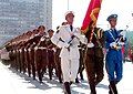 The tri-service color guard leading the battalion during a parade.