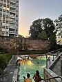 Outdoor pool at QC Terme Milano with spanish walls in the background.