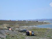 20 June 1999. Looking from the landing strip towards Bathurst Inlet. Visible are the old Hudson's Bay Company buildings in their traditional red and white colours.