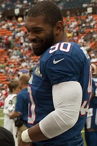 Julius Peppers of the Pro Bowl NFC team smiling and looking downwards