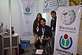 Butch Bustria and Belinda Ballesteros of Wikimedia Philippines with volunteer Felix Fajardo at the booth at the NCS event