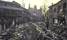 A very large number of bicycles parked along a street in Shanghai