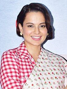 Kangana Ranaut is smiling at the camera