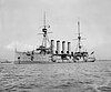 A black and white picture of a large ship with four funnels