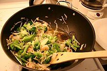 Ingredients being fried in a wok