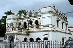 A large two-storey building with white decorated facade