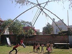 Children standing in a queue for the swing