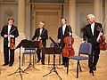 Image 12A modern string quartet. In the 2000s, string quartets from the Classical era are the core of the chamber music literature. From left to right: violin 1, violin 2, cello, viola (from Classical period (music))