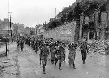 German prisoners of war escorted by American soldiers in Cherbourg in 1944.