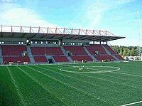 Empty stadium stands, seen from across the pitch