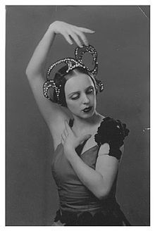 Nifontova in costume with her arms in fourth position