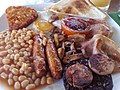 Image 18The full breakfast is among the best known British dishes, consisting of fried egg, sausage, bacon, mushrooms, baked beans, toast, fried tomatoes, and sometimes white or black pudding. (from Culture of the United Kingdom)