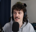 Image 116Stand-up comedian Kurtis Conner wearing early 2020s mullet hairstyle and mustache. (from 2020s in fashion)