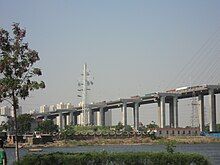 a white slat semaphore tower on an island