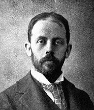 Head of a man in his thirties with closely trimmed hair and beard