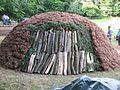 Pile with various layers (wood, spruce brushwood (Fichtenreisig), grass sods)