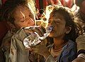 Image 21A young girl drinking bottled water (from Water)