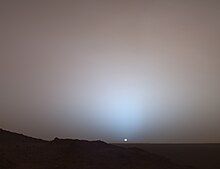 photograph of hazy and distant sunset