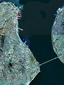 A satellite view of The Narrows with Staten Island (on the west / left) and Brooklyn / Long Island (on the east / right) connected by the prominent landmark Verrazzano-Narrows Bridge