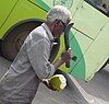 Cutting open a tender coconut. A popular drink.