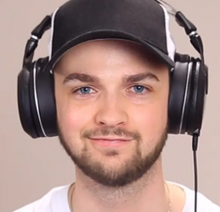 Ali A wearing headphones