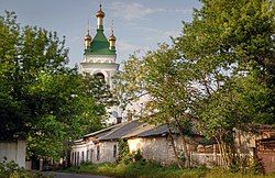 Old street with the view at the St. Nicholas Church