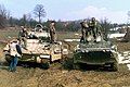 An American M2 Bradley and a Russian BTR-80 during a patrol near Zvornik