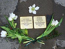 Memorial ground stones, surrounded by flowers