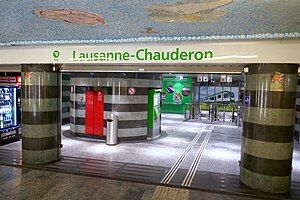 Underground entrance with the station name in green letters