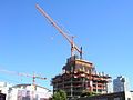 The two tower cranes on July 25, 2006. Most of the giant advertisement for the towers can be seen behind the smaller crane.