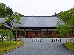 A wooden building with slightly raised floor and wooden sliding doors.