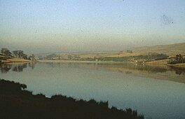 A lake surrounded by low hills