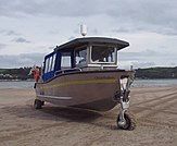 Three-wheeled amphibious boat on the sand