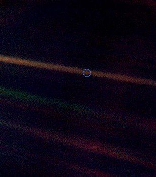 Pale blue dot image with a wider field of view to show more background.