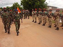 New Forces general Bakayoko reviews his troops who are standing at attention in regularized uniforms