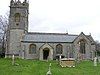 Gray stone building with square tower and slate roof.