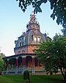 Large ornate house, with a level of decoration more usually associated with public buildings. Originally more modest in conception, the house was built in 1860 and the dome was added during 1872–1876. Armour–Stiner House, Irvington, New York.[6]