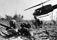 A soldier crawls on the ground during the Vietnam War.