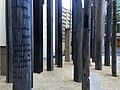 Close up view of one of the timber pillars with Latin and Aboriginal language engravings