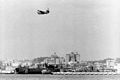 USS Duval County (LST-758) in drydock at San Diego, September 1960, with Martin P5M Marlin flying boat passing overhead